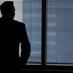 Businessman staring out of window